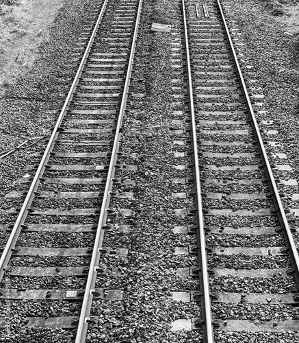 Conerging railway tracks in black and white