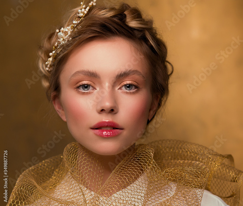 Portrait of a beautiful woman. Mademoiselle. Yellow and gold color. Hairpin in the hair. There is a shawl on the neck. photo