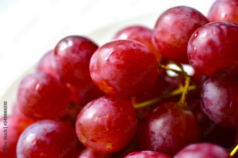 Bunch of red and large grapes on a white background Bunch of red and large grapes on a white background