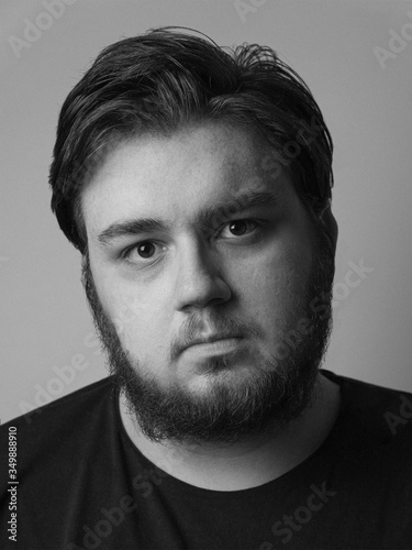 Black and white portrait of young bearded man 