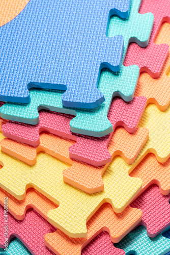 Macro photo of the details of a foam. Colored rubber mat puzzle for children.