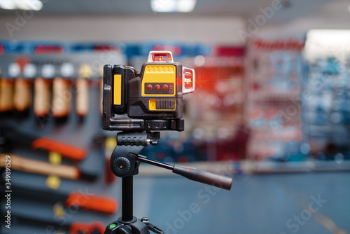 Laser level on tripod in tool store, nobody