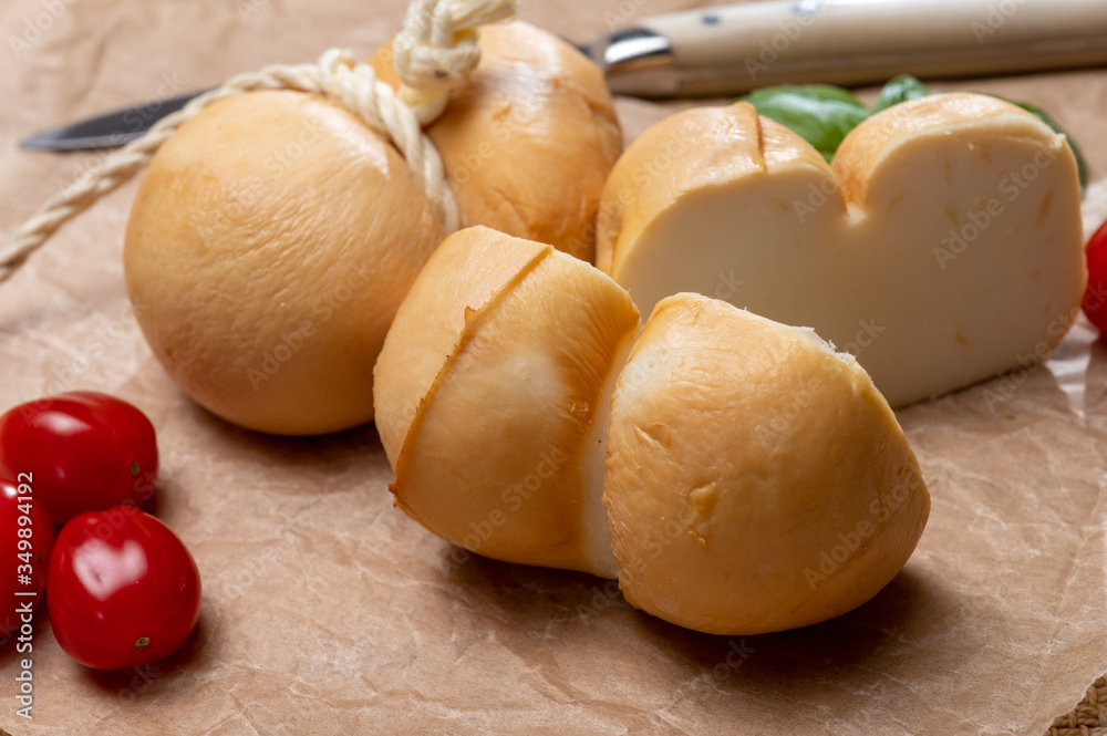 Italian semi hard handmade smoked scamorza cheese, from cow milk from Apulia or Calabria regions Italian semi hard handmade smoked scamorza cheese, from cow milk from Apulia or Calabria regions