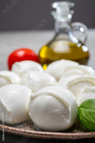Tasty italian food, fresh white buffalo mozzarella soft cheese balls from Campania, tomatoes, fresh basil and olive oil #349895181