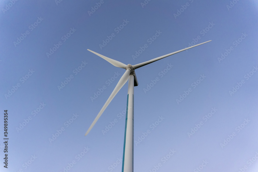 White wind power turbines or windmill generators farm for producing electricity with renewable energy. It is the way to save environmental. White wind power turbines or windmill generators farm for producing electricity with renewable energy. It is the way to save environmental.