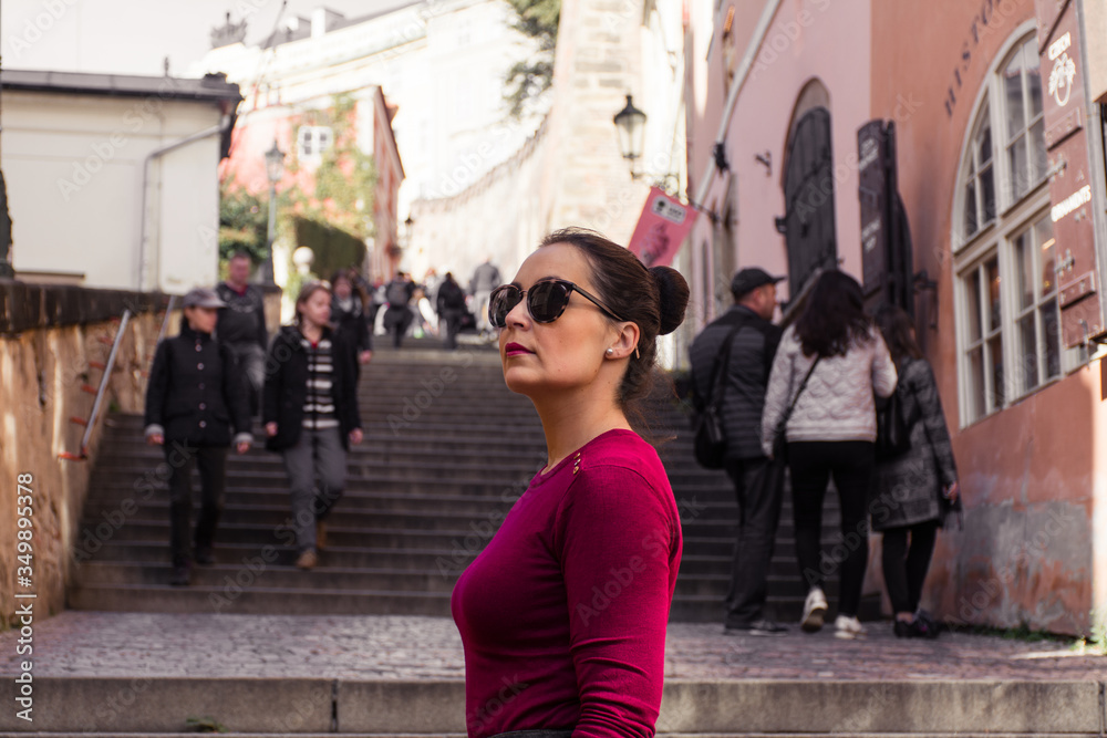 Beautiful woman climbing stairs with sunglasses, Prague