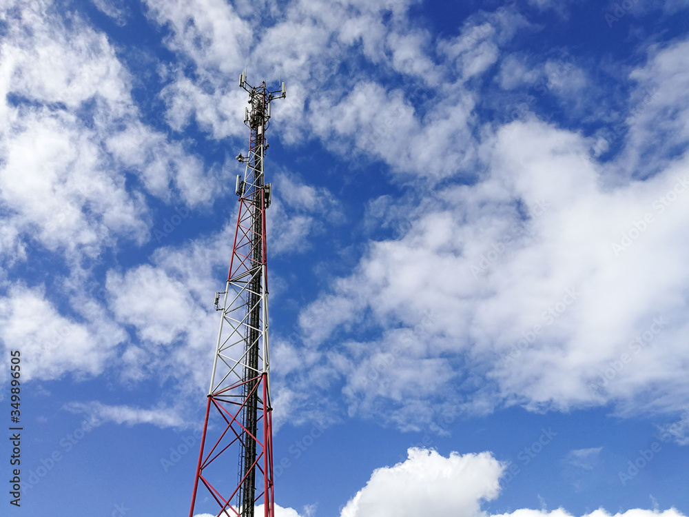 GSM repeater tower in front of blue cloudy sky