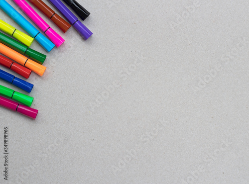 Colorful pens on kraft background. Colorful marker pens. photo