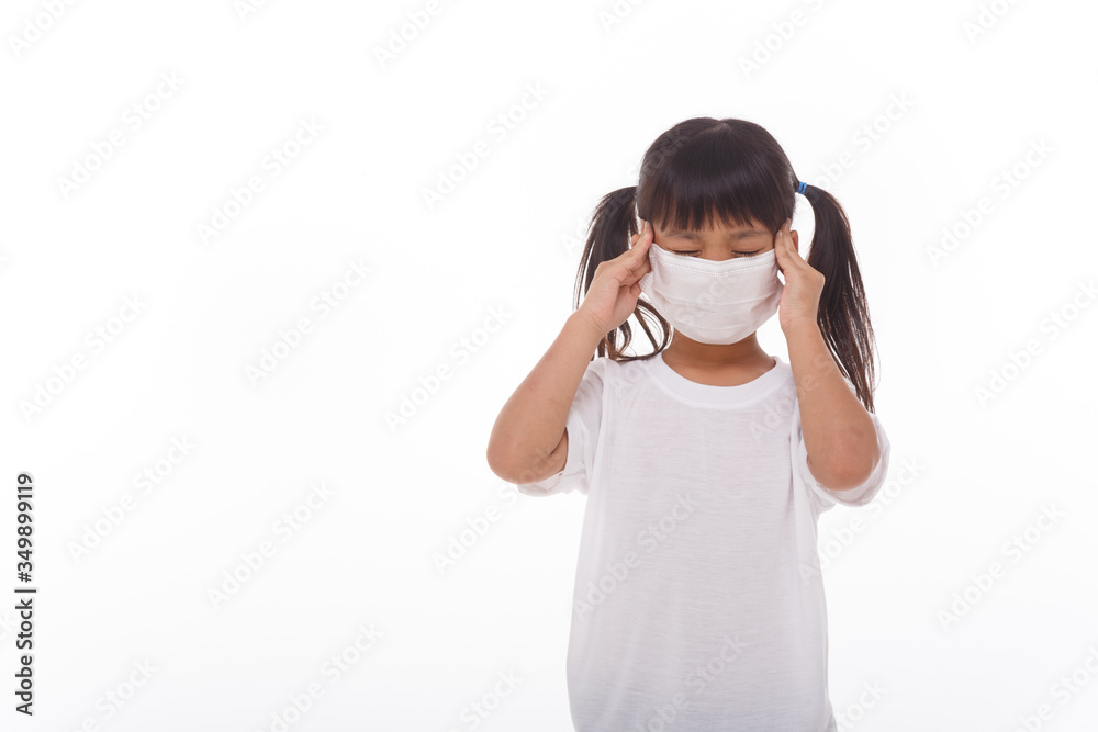 Asian child wearing a medical mask is feeling headache on white background. Asian child wearing a medical mask is feeling headache on white background.