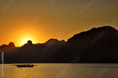 Traditional boat during sunset at Komodo National Park, Indonesia. 