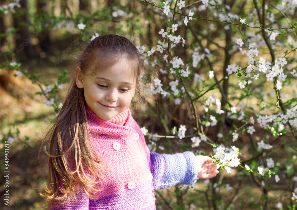portrait of a little girl in a flowered garden portrait of a little girl in a flowered garden