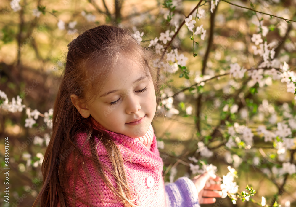 portrait of a little girl in a flowered garden portrait of a little girl in a flowered garden
