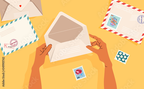 Hands holding an opened envelope. Envelopes, post stamps, and postcards on the table. Top-down view. Modern vector illustrated banner, card design. Correspondence and postal delivery concept.
