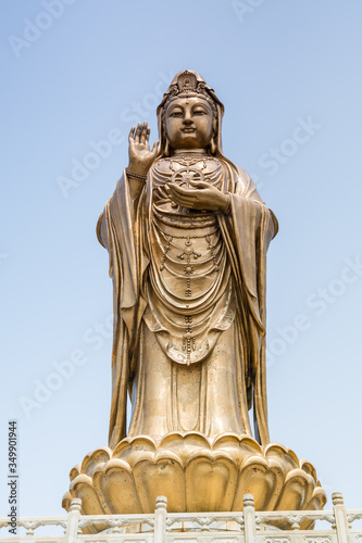 Golden statue of bodhisattva guanyin Mount Luojia, which lies in the Lotus Sea to the southeast of Putuo Mountain, Zhoushan, Zhejiang, the place where Bodhisattva Guanyin practiced Buddhism