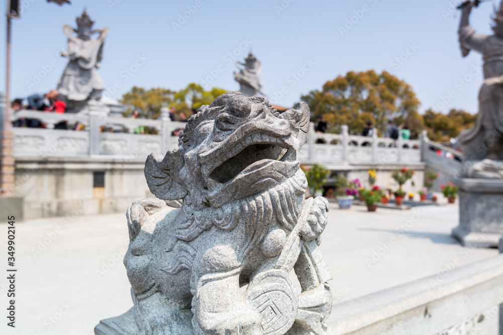 Statue of the mythological animal in front of Golden statue of bodhisattva guanyin Mount Luojia, Zhoushan, Zhejiang, the place where Bodhisattva Guanyin practiced Buddhism