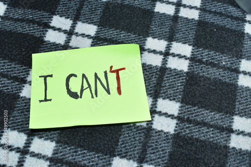 Positive attitude and motivation concept for self belief. " I Can" is written with black and letter 'T' with red pen.