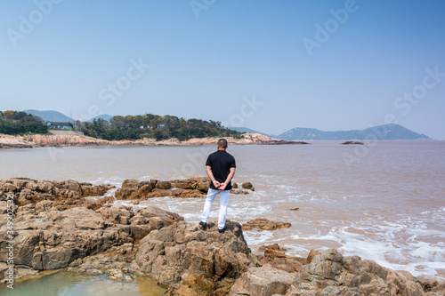 Tourist at the seaside at Mount Luojia  which lies in the Lotus Sea to the southeast of Putuo Mountain  Zhoushan  Zhejiang  the place where Bodhisattva Guanyin practiced Buddhism
