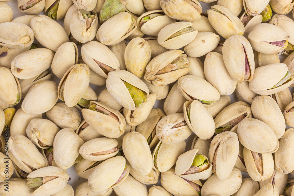 background of roasted and salted pistachio nuts background of roasted and salted pistachio nuts