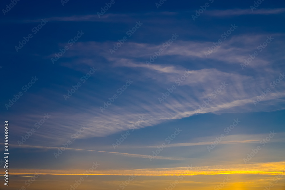 magical sunset, beautiful light from the sun, the trace of an airplane in the sky, colored lines in the sky, Cirrus clouds