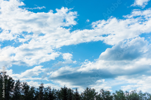 Blue sky with floating white clouds. The background.