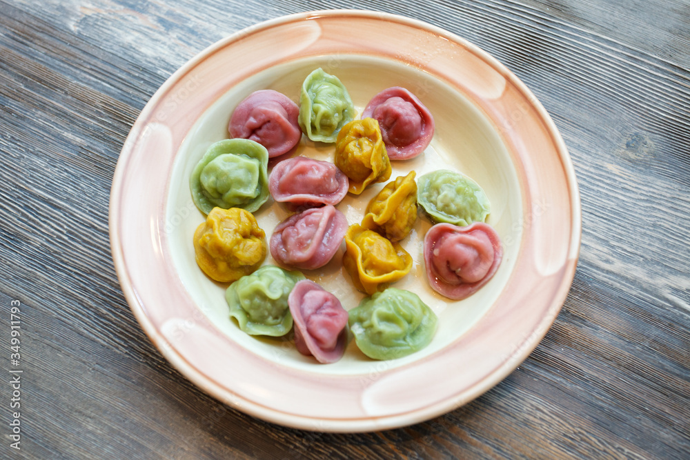 Ready colorful dumplings. Boiled dumplings on a plate. Pelmeni. Pelmeny. Top view, part of kids menu Ready colorful dumplings. Boiled dumplings on a plate. Pelmeni. Pelmeny. Top view, part of kids menu