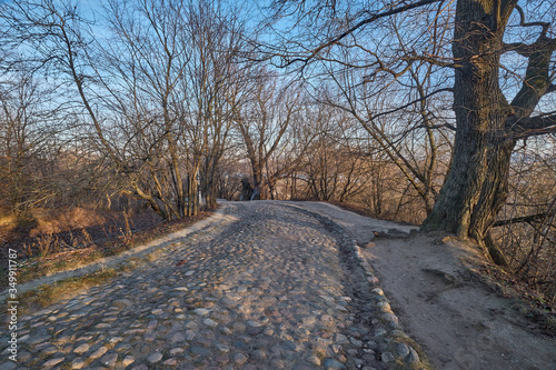 Old cobblestone road in a hilly park. Moscow, Kolomenskoye park