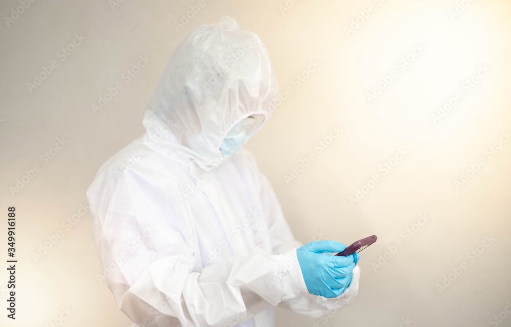 Fototapeta premium Doctor is wearing PPE suit and looking for corona/covid-19 virus infected patient's laboratory on application phone report , For protection Coronavirus (COVID19) epidemic