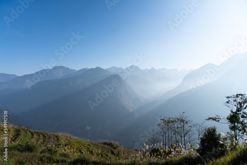Beautiful of layer dark blue mountain  landscape with fog and forest on foreground. sunrise and sunset in mountains.   nice landscape