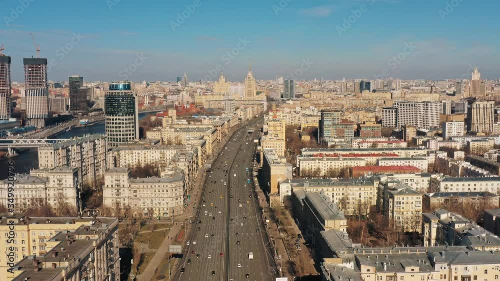 Aerial drone zoom in top shot over large Moscow city centre road, in spring under bright sky. Drone top shot flying over Moscow centre and cars in rush hours during spring sunny day Aerial drone zoom in top shot over large Moscow city centre road, in spring under bright sky. Drone top shot flying over Moscow centre and cars in rush hours during spring sunny day