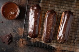 Chocolate glazed profiteroles on a dark background. handmade dessert. horizontal image. top view