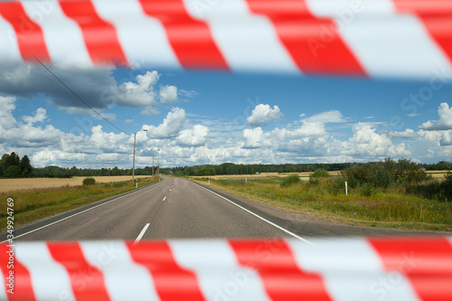 Photos Road with fields with warning tape