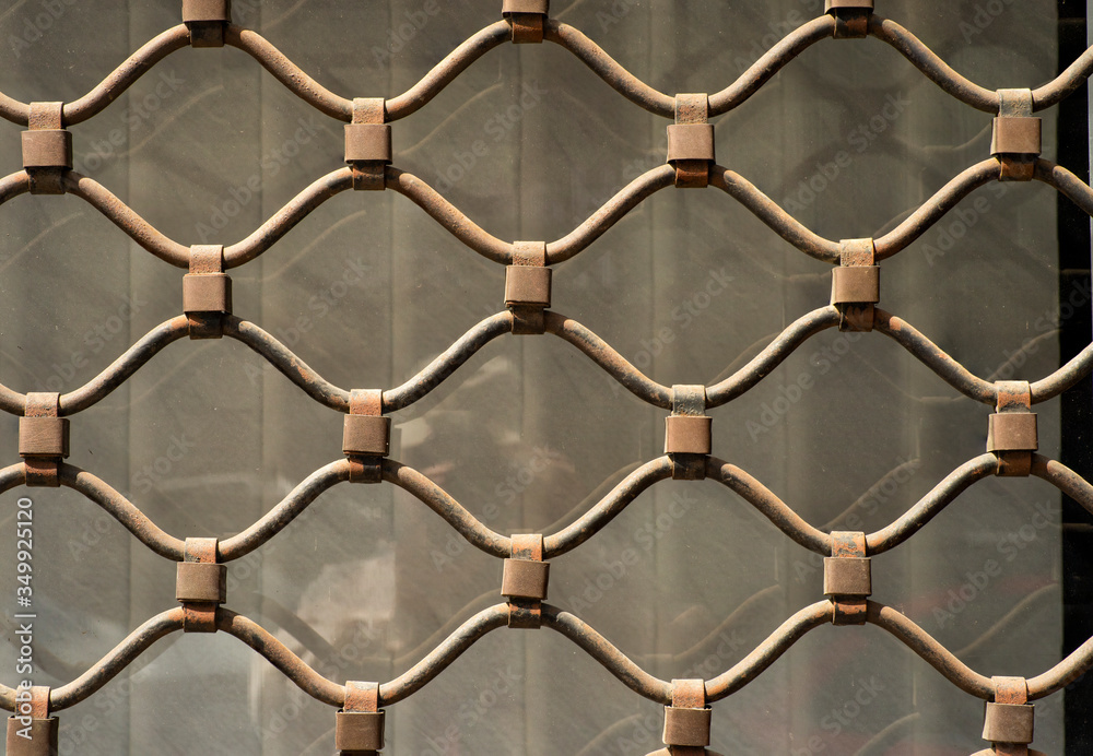 Naklejka premium decorative elements of wrought iron grilles in the window