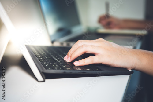 Blurred soft images, the Hand of business people Which is placed on the keyboard of the notebook is printing data The details of the plan for success at workplace