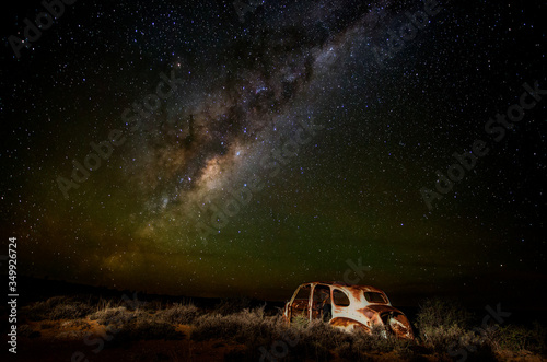very old car wreck under milky way, starscape, nightscape