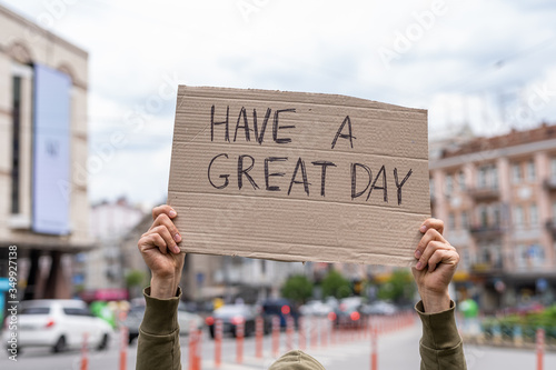Have a great day card. Happy kind wish. Hand holding sign outside on street. Social public messages on banners outside on streets. reflection phrases self love. support and cheer up