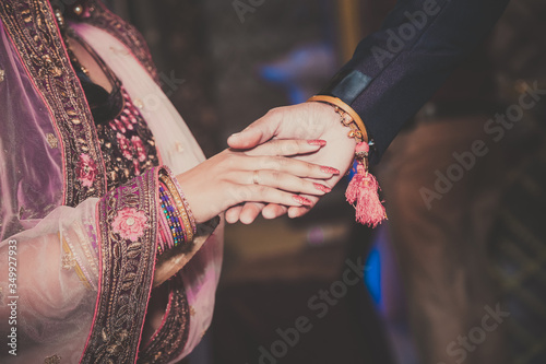 Close up of Indian couple's hands at a wedding