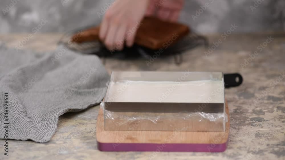 Woman is preparing chocolate cake with milk cream. The process of making the chocolate cake. Woman is preparing chocolate cake with milk cream. The process of making the chocolate cake.