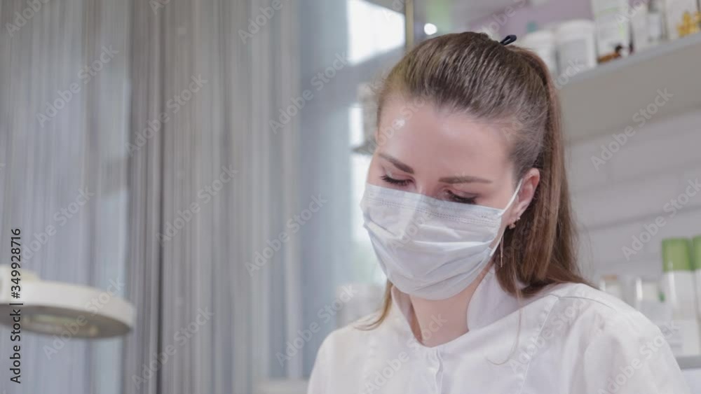 Beautician in medical mask on the procedure. Beautician in medical mask on the procedure.