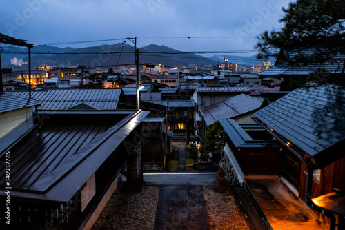 Takayama, Japan Gifu prefecture in Japan with skyline cityscape of roof mountain town village in dark night with illuminated buildings