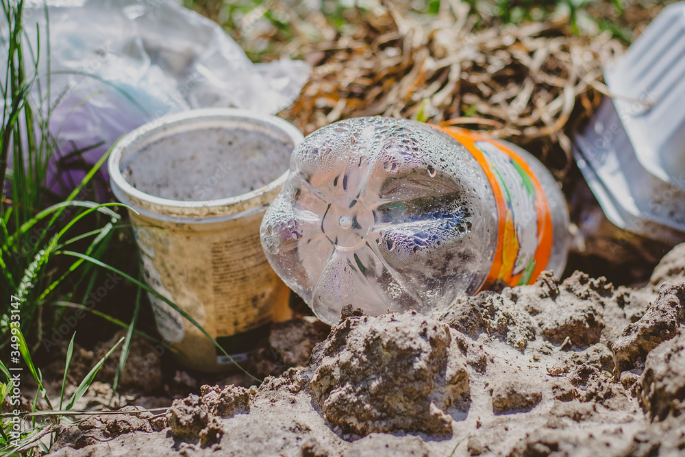 Obraz premium Trash and garbage in the forest, plastic bottles, enviromental pollution concept. Ecological problem, catastrophe, destruction of the ecological system