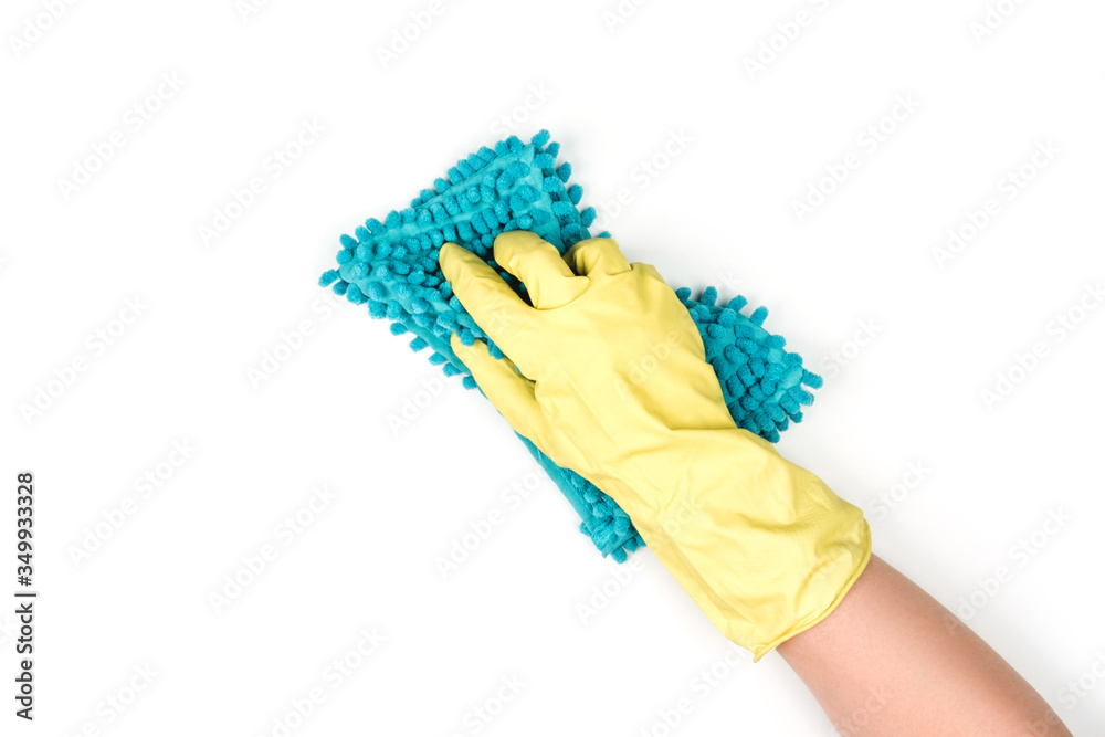 A rubber-gloved hand holds a rag and wipes the surface. A rubber-gloved hand holds a rag and wipes the surface.