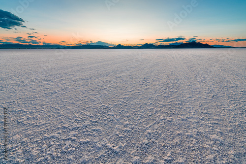 Bonneville Salt Flats colorful landscape twilight sunset near Salt Lake City  Utah and silhouette view of mountains and sun setting behind clouds