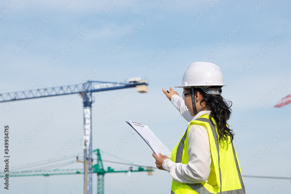 Asian engineer working at site of a large building project,Thailand people,Work overtime at construction site Asian engineer working at site of a large building project,Thailand people,Work overtime at construction site