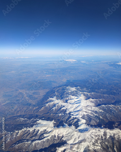 High fly above European snow covered mountains