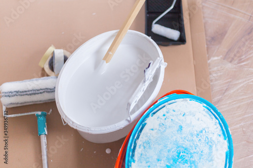 Wallpaper Mural Paint bucket with white wall paint and with wooden stirring rod and drip grate handcraft paint roller home renovation tools do it yourself Torontodigital.ca