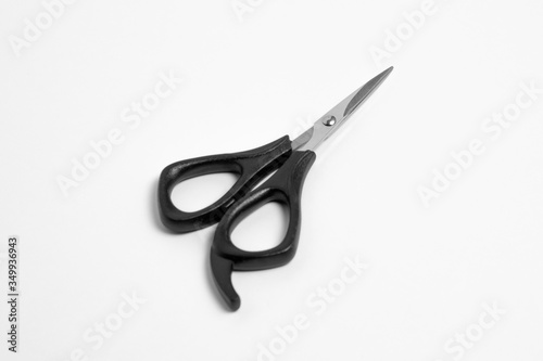 Black scissors isolated white background with a clipping path, close up open scissors object. Top view.High-resolution photo.