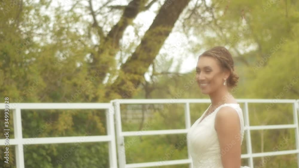 A bride laughing and smiling as she poses for wedding photos at her rustic wedding A bride laughing and smiling as she poses for wedding photos at her rustic wedding