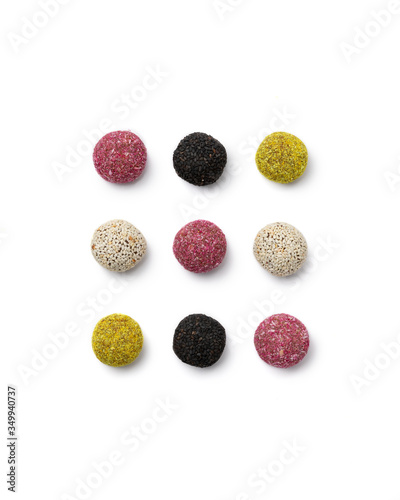 Colorful vegan candies energy balls on isolated white background