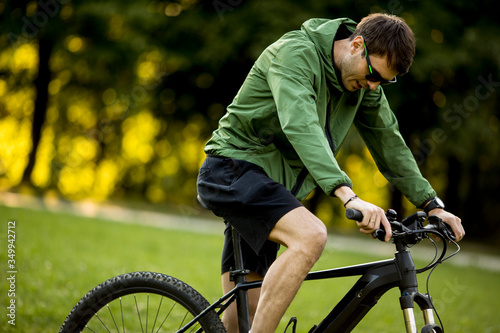 Young man riding ebike in nature