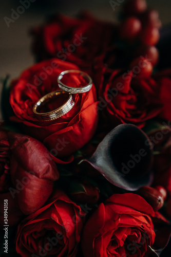 Wedding rings on the red flowers, wedding concept, Marsala color
